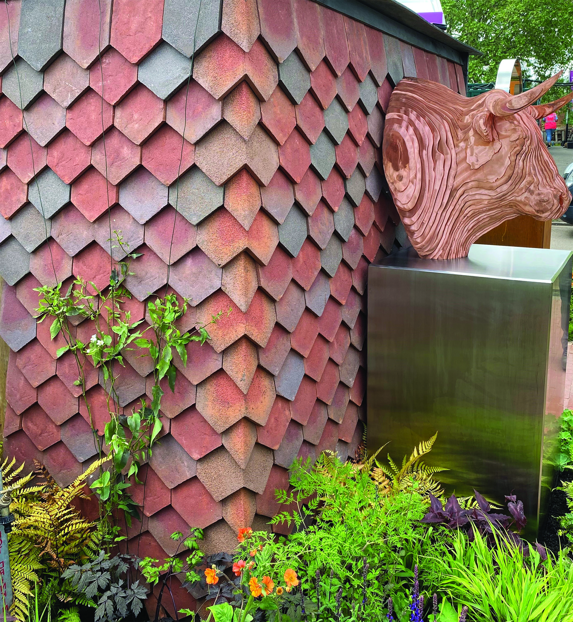 Garden shelter clad in handmade Dreadnought arrowhead tiles provides backdrop for Tom Hiscocks El Toro at Chelsea Flower Show 2024